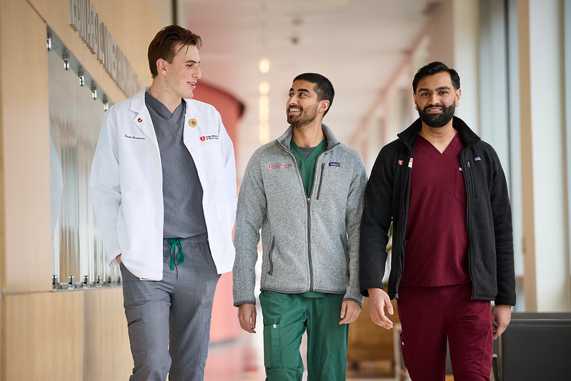 Three students walking down a CMSRU hallway