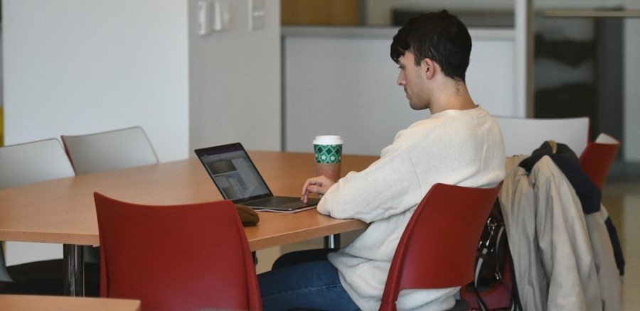 A CMSRU student works on their computer.