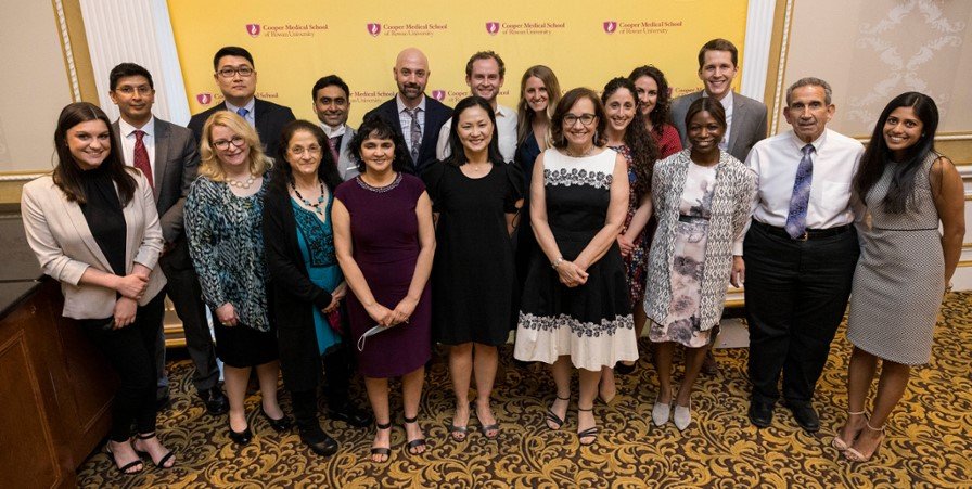 A group of faculty members featured at an awards banquet.