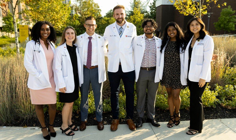 A group of students from CMSRU's Class of 2026 pose together for a photo at their White Coat Ceremony.