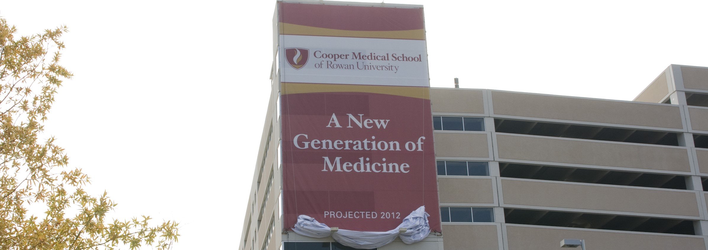 A photo featuring a banner posted on the parking garage that reading, A New Generation of Medicine.