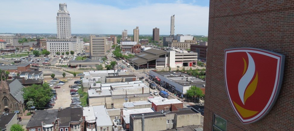 An aerial view of Camden, NJ, including the CMSRU shield on the CMSRU Medical Education Building.