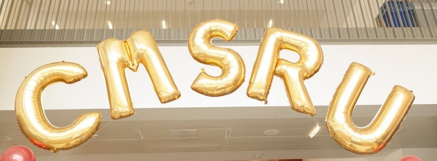 A photo of a balloon arch that spells: CMSRU.