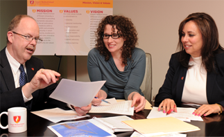 A group of CMSRU staff members at a meeting.