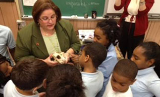 A photo of children featured standing with Charlene Williams, PhD, at Lanning Square Elementary School. 