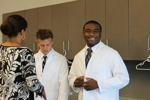 A CMSRU student is featured wearing their white coat.