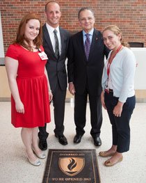 CMSRU students Erica Schramm, Michael Coletta and Marci Fornari with CMSRU Dean Paul Katz, MD, at the site of the now-buried CMSRU Time Capsule,