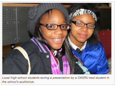 A photo of local high school students during a presentation by a CMSRU med student in the CMSRU auditorium.