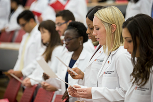 A group of CMSRU students are shown reciting the Hippocratic Oath.