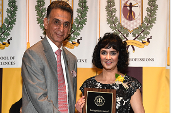 Rowan University President Ali Houshmand, PhD, is phorographed with Sangita Phadtare, PhD, associate professor of biomedical sciences at CMSRU. Dr. Phadtare was recently honored during the Annual Celebrating Excellence Awards ceremony at Rowan University's main campus in Glassboro, NJ.