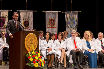 Rowan University President, Ali Houshmand is shown on stage speaking to the crowd at CMSRU's White Coat Ceremony.