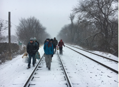 CMSRU students walk along the railroad tracks in the snow.