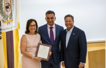 CMSRU Dean Annette C. Reboli and Rowan University President Ali Houshmand accept a U.S. Congressional Proclamation from Congressman Donald Norcross (far right) in honor of winning the AAMC Spencer Foreman Award.