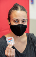 A CMSRU student shows off a sticker that states they received the COVID-19 vaccine.