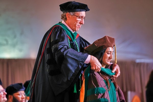 This is an image of a medical student being hooded by an advisor