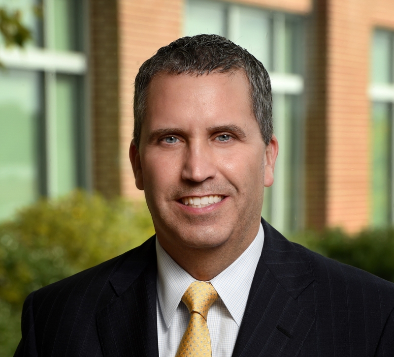 A professional headshot of Mark Byrne