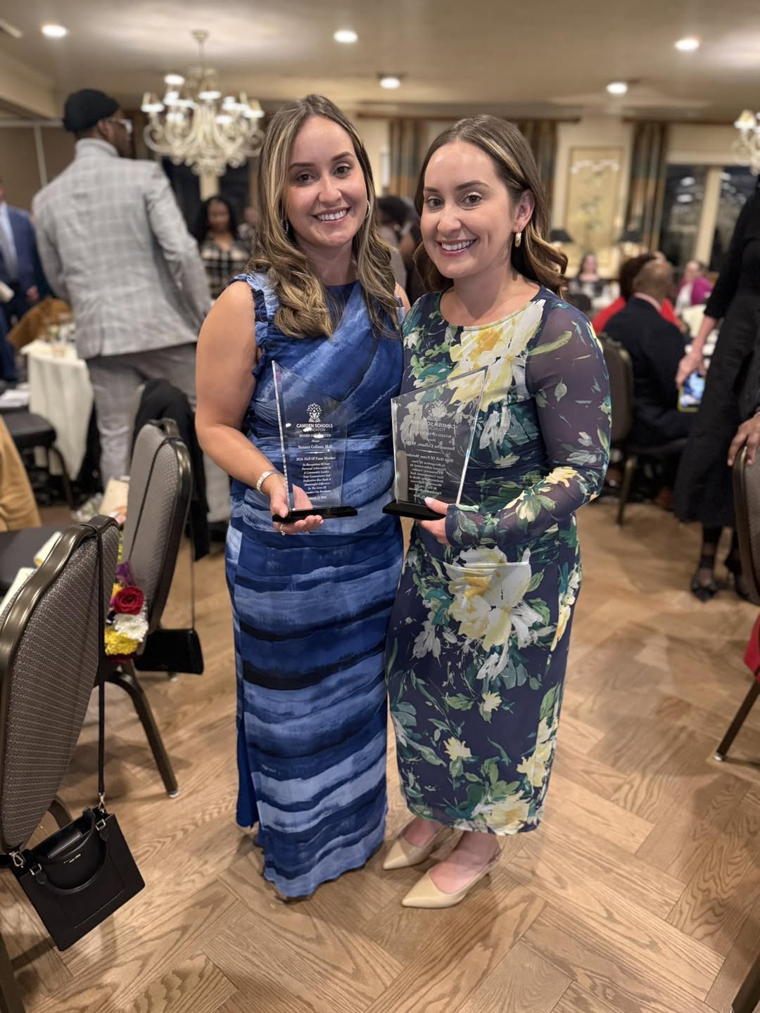 A photo of the Collazo twins and their award