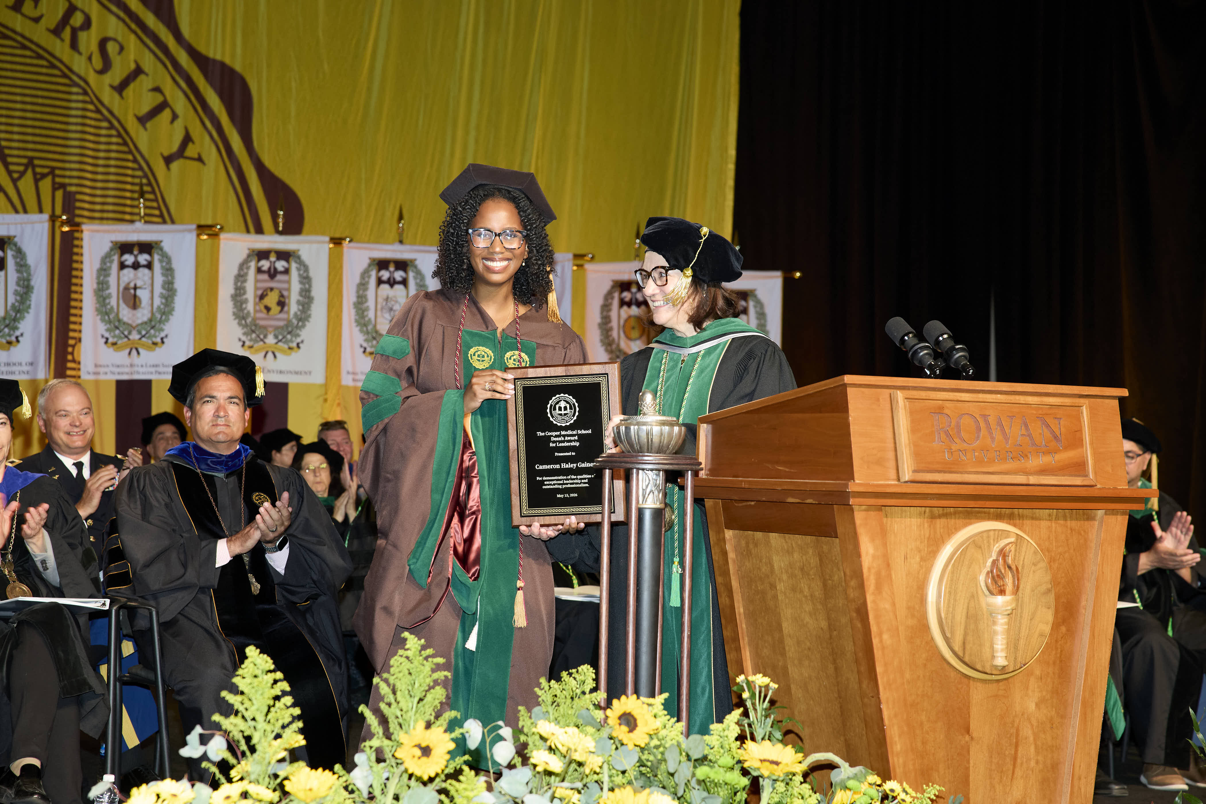 A student accepting her Dean's award by Dean Annette Reboli