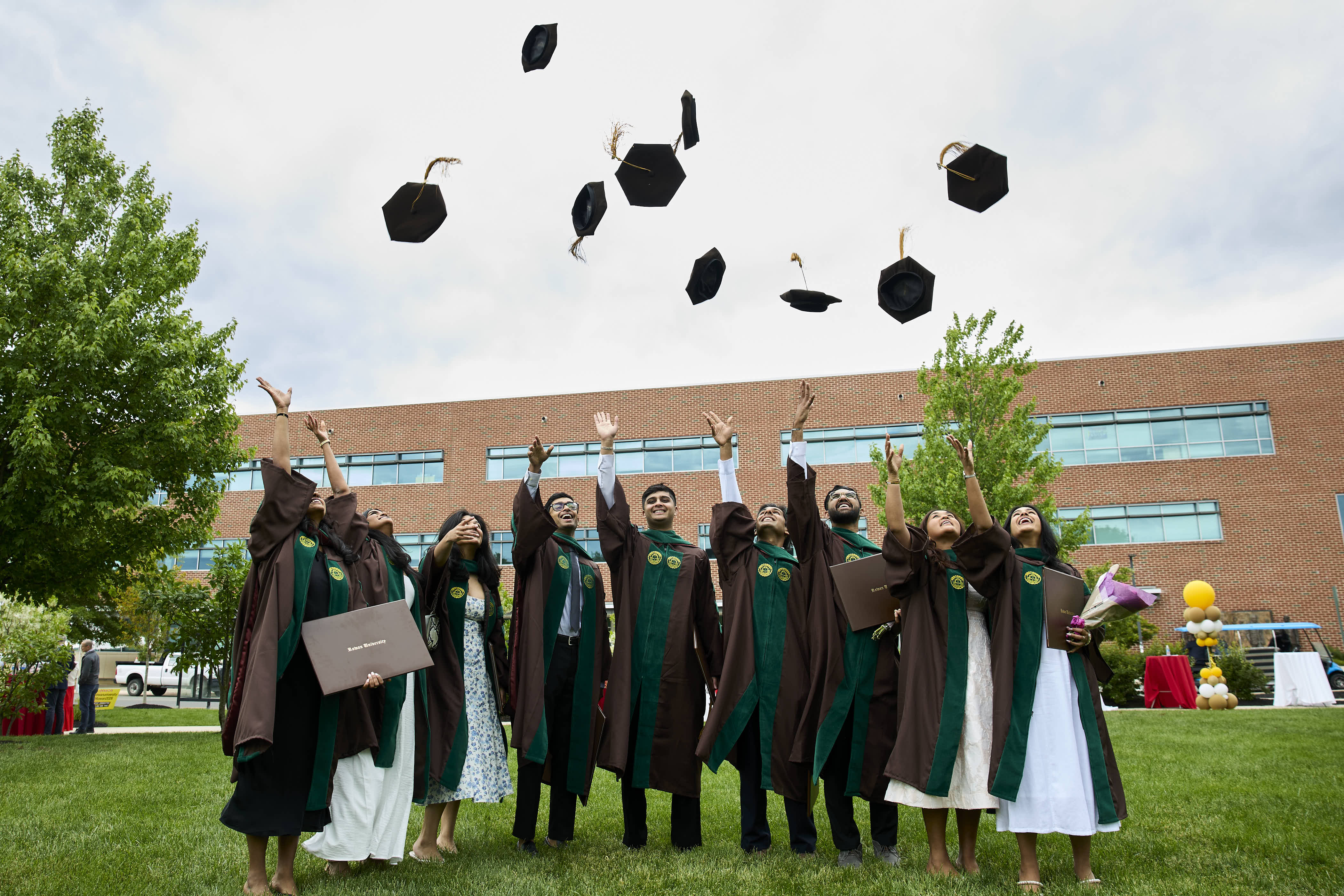 A photo of a students throwing their cap in the air.
