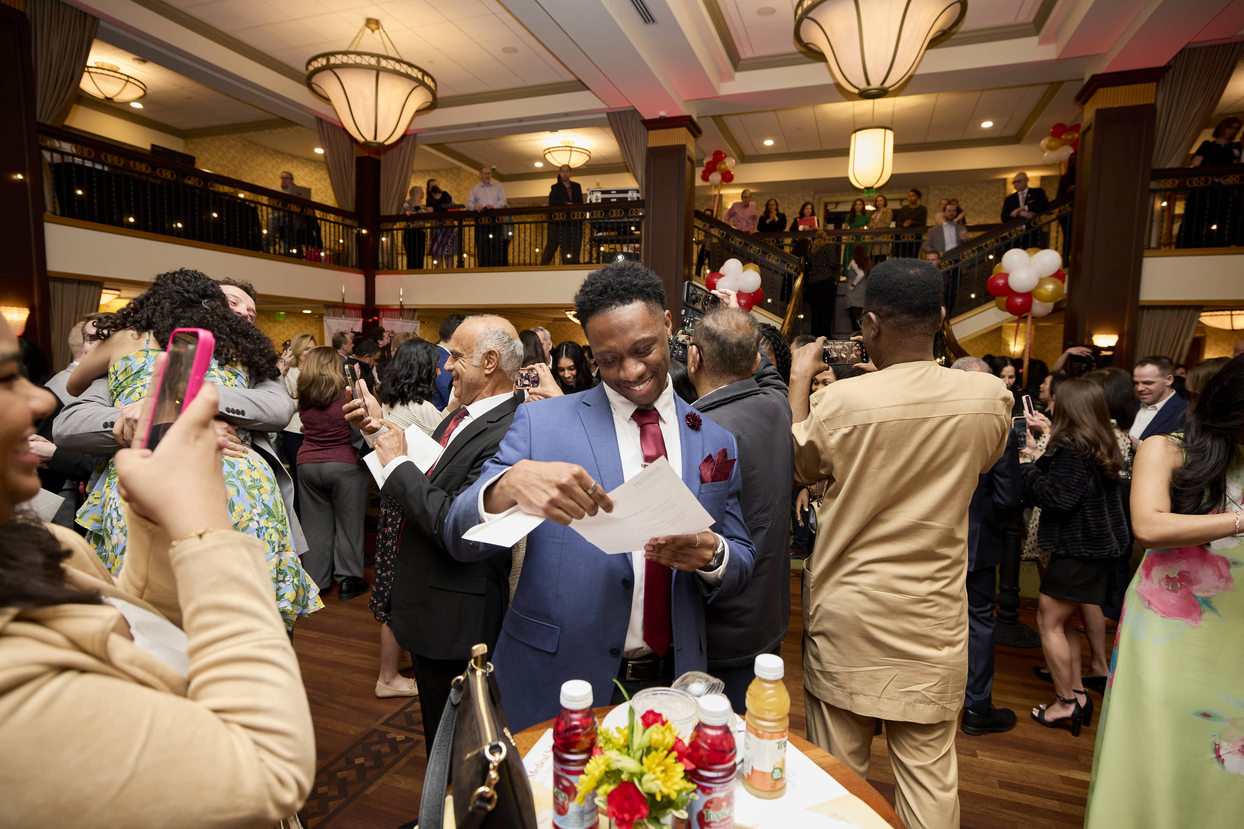 A student opening their residency envelope on Match Day 2026