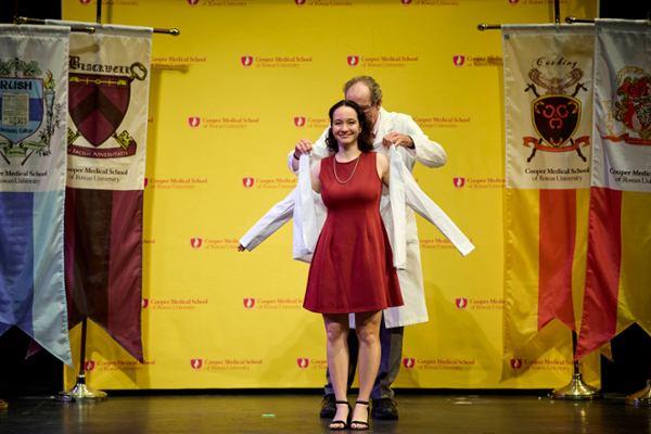 A medical student is cloaked during her White Coat Ceremony on Aug. 7