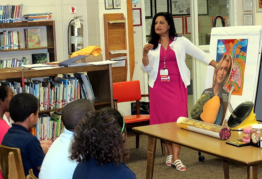A CMSRU faculty member speaks to a group of children at a local elementary school.