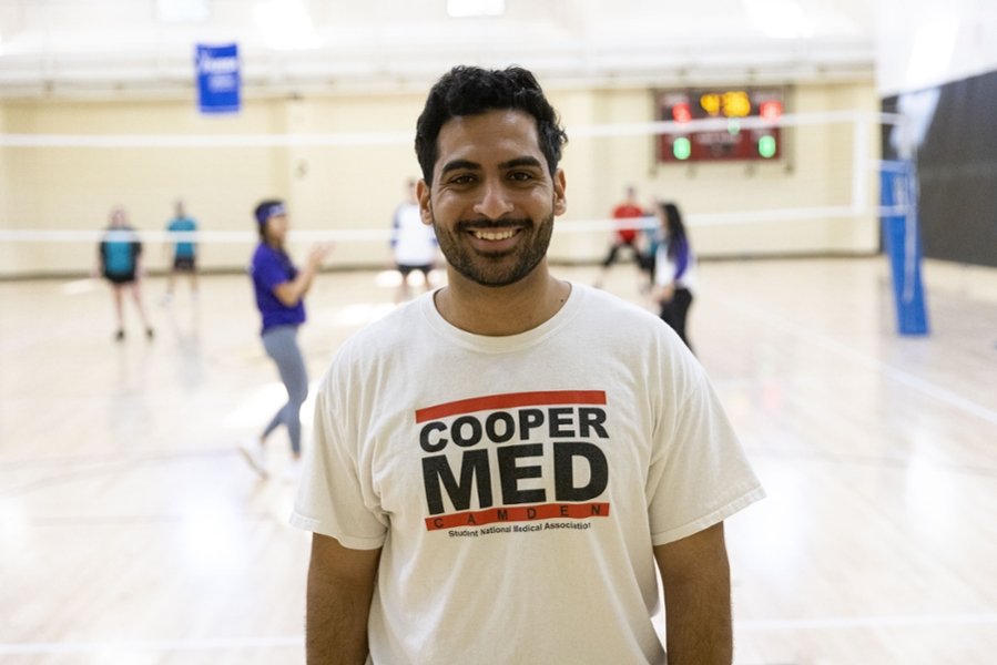 A CMSRU student poses in their Cooper Med t-shirt, a shirt that promotes the Student National Medical Association - SNMA - Chapter at CMSRU.