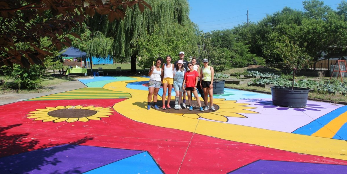 A group of CMSRU students pose with a brand new ground mural that they painted in a local park in Camden, NJ.
