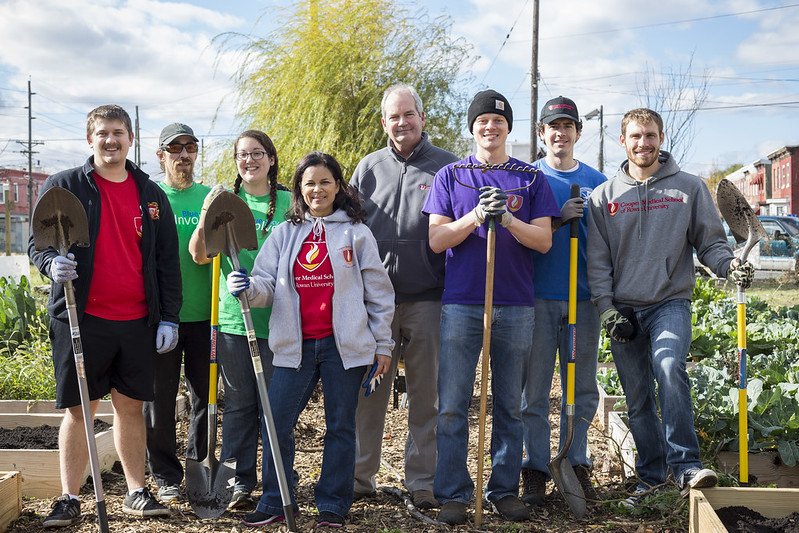 A group of CMSRU students and faculty members are featured working on community service.