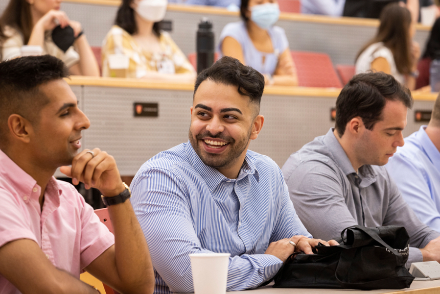 A candid photo of CMSRU students talking and laughing with each other at an Orientation session.