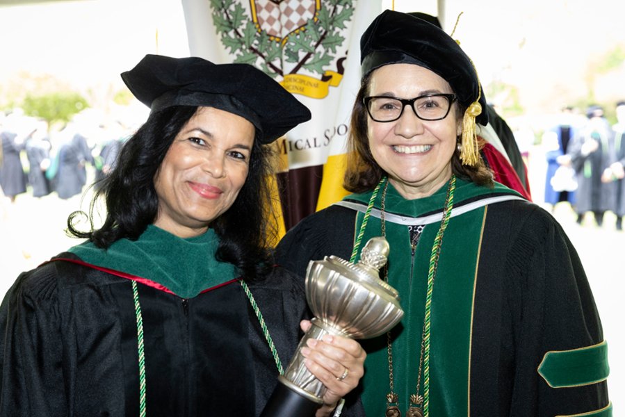 A photo of Jocelyn Mitchell-Williams, MD, PhD, associate dean for medical education at CMSRU, and Annette C. Reboli, MD, dean of CMSRU in regalia at a CMSRU Commencement ceremony.