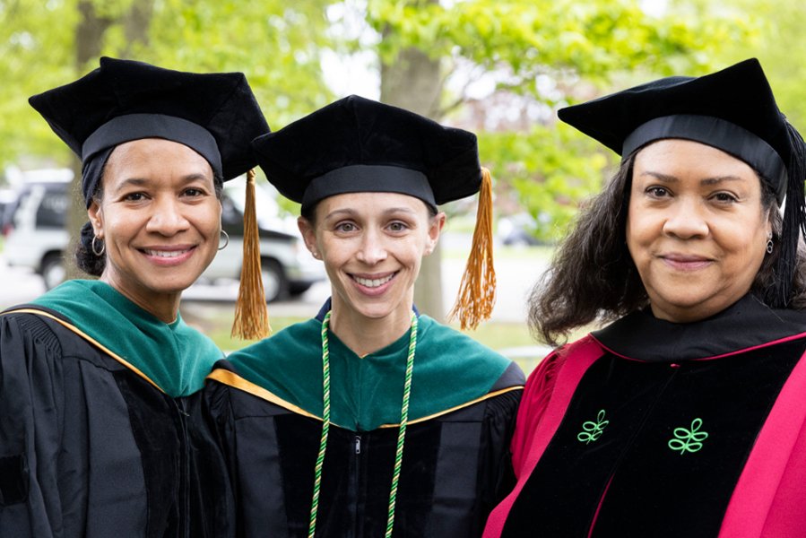 Three CMSRU faculty members pose for a photo at a CMSRU Commencement ceremony.