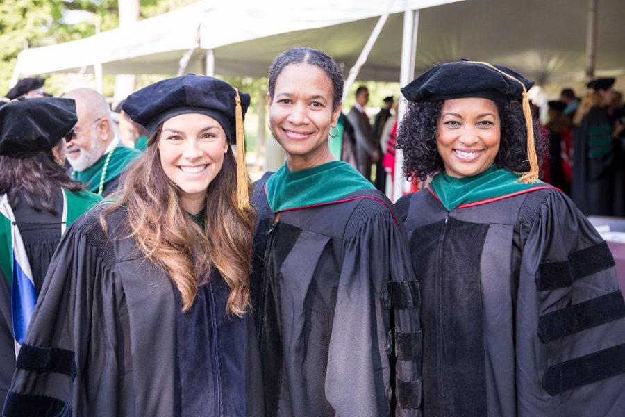 A photo featuring three CMSRU faculty members at a CMSRU Commencement ceremony.