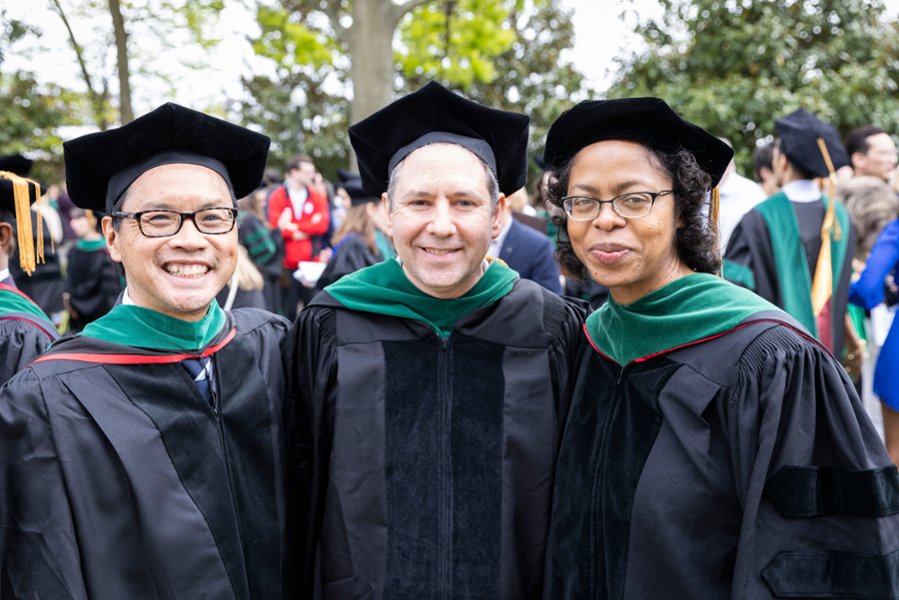 Three CMSRU faculty members pose for a photo at a CMSRU Commencement ceremony.