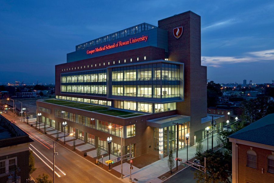 A photo featuring the exterior of the CMSRU Medical Education Building at night. 