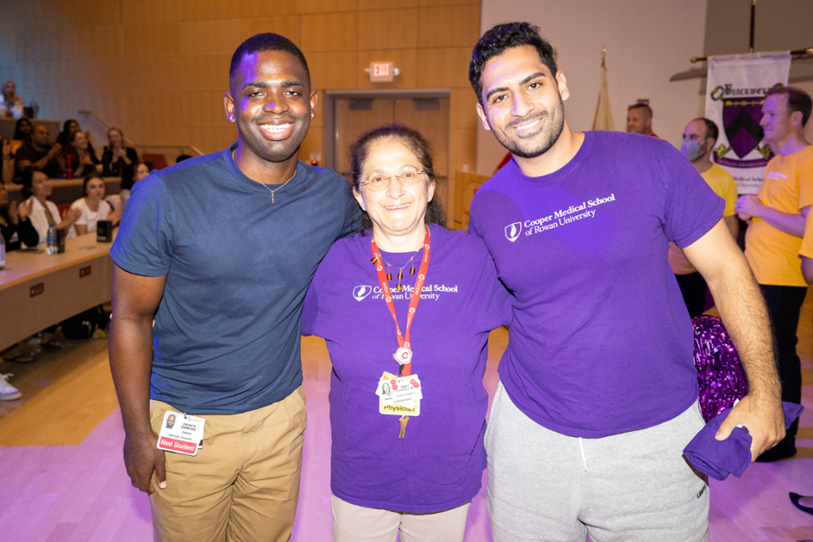 Two CMSRU students pose with a faculty member at the Advisory College Sorting Ceremony.